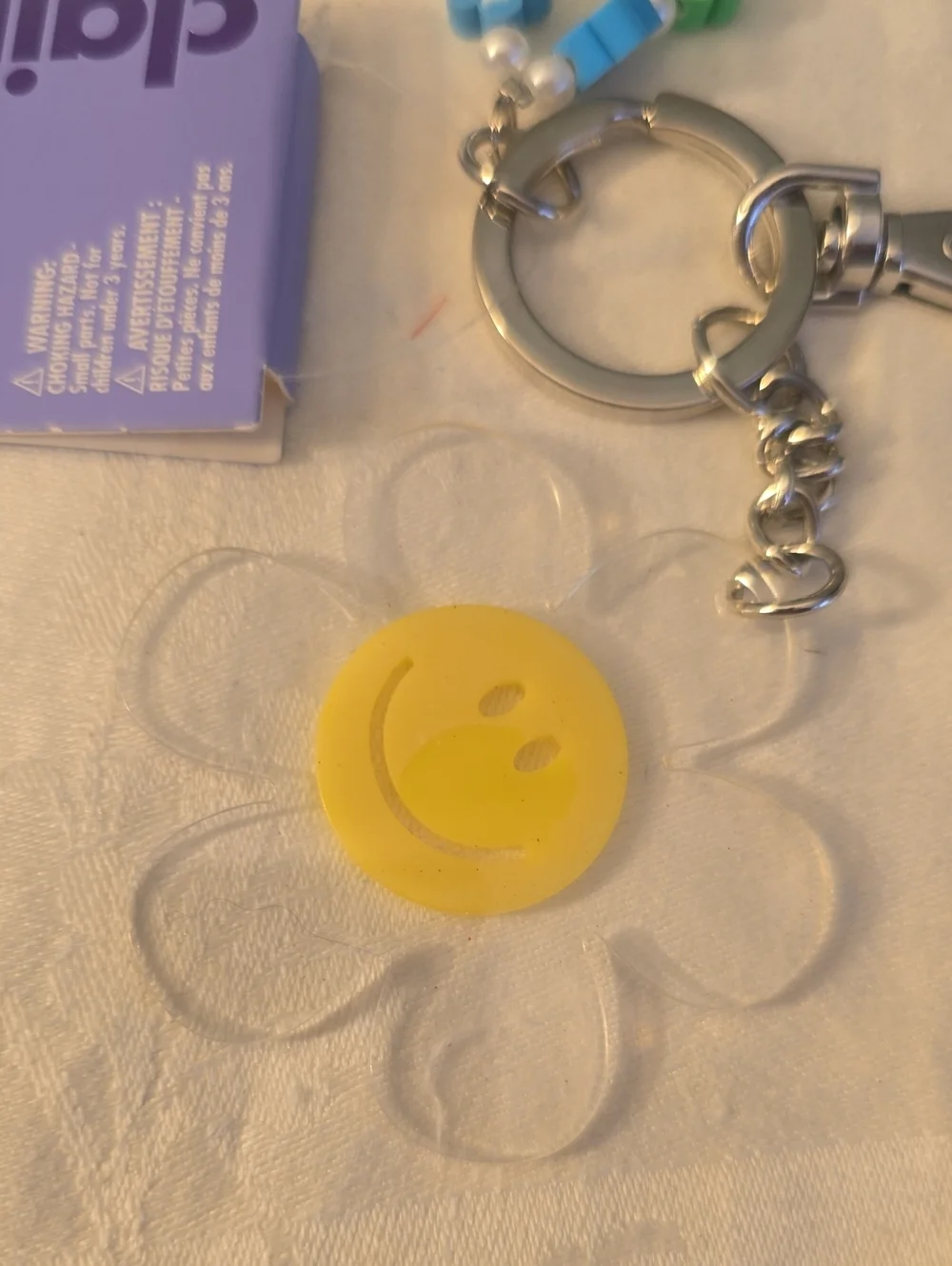 Claire's Multicolor Flower Bead Charm Keychain with Yellow Smile Accent